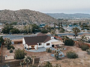 A single-story house with a covered patio and a fenced backyard. - License To Chill | Pool + Hot Tub | Enclosed Yard (Yucca Valley)