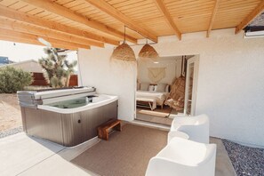 A hot tub area with a wooden ceiling, a bed, and a hanging chair. - License To Chill | Pool + Hot Tub | Enclosed Yard (Yucca Valley)