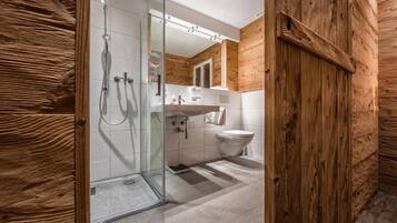 Shower, hair dryer, slippers, towels