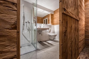 Shower, hair dryer, slippers, towels
