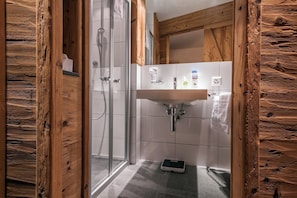 Shower, hair dryer, slippers, towels