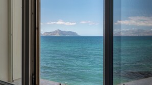 A view through a window of a coastal area with calm sea and distant mountains. - Villetta Ficarazzi by Wonderful Italy (Ficarazzi)