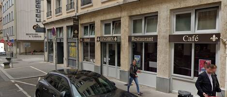 A building with multiple establishments including a hotel, restaurant, and café.