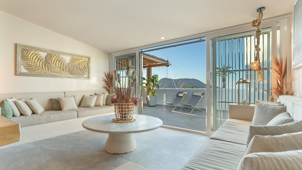 A modern living room with a sofa, a round coffee table, and a large window with a view of mountains. - Villa Oceania Entire with Sea View, Wi-Fi and Air Conditioning (Chayofa)