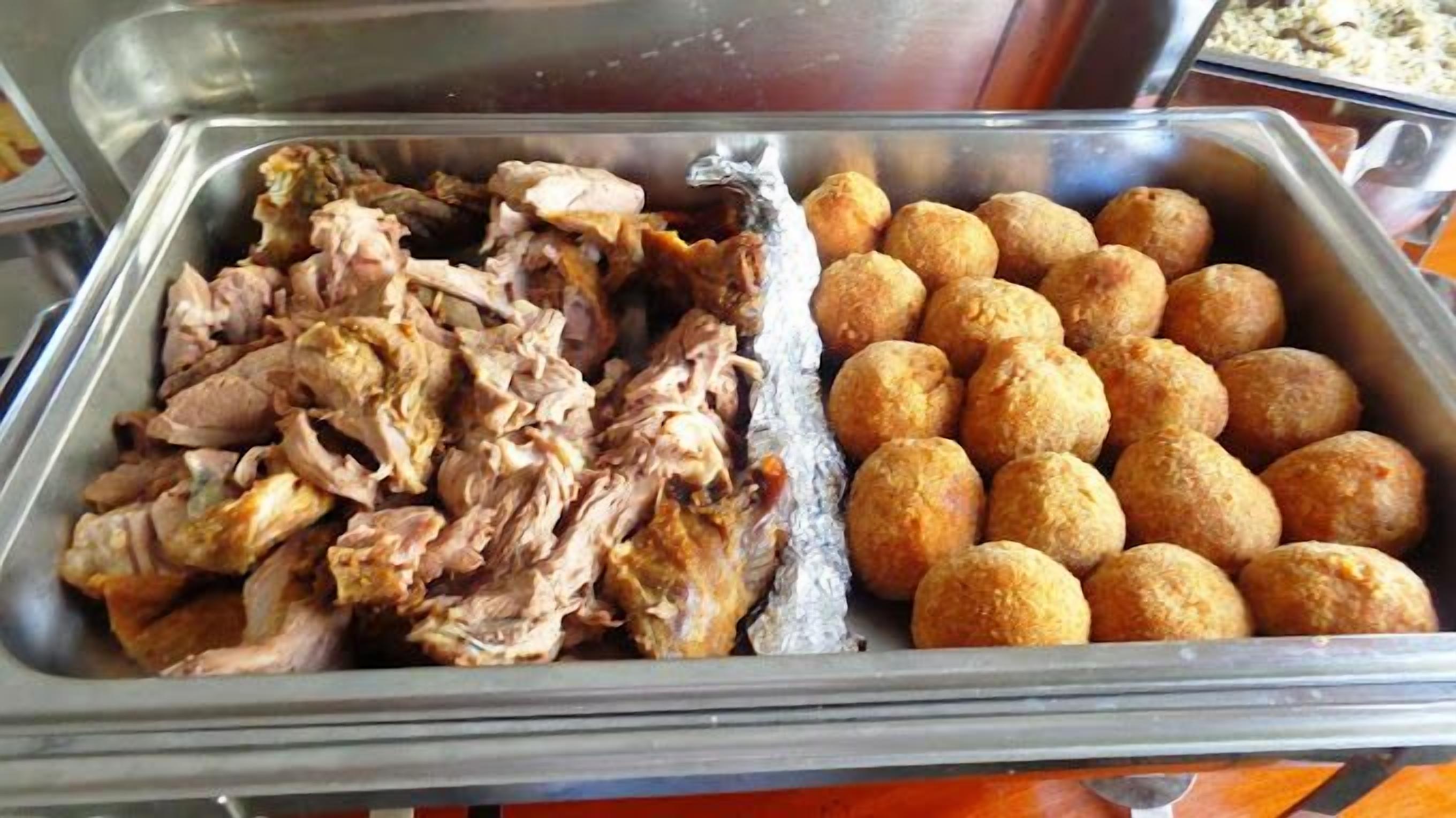 A buffet with pulled pork and cheese balls.