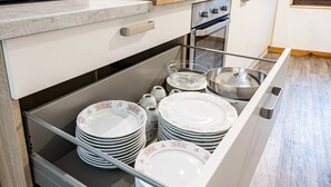 A kitchen with a built-in dishwasher, stainless steel appliances, and a wooden countertop.