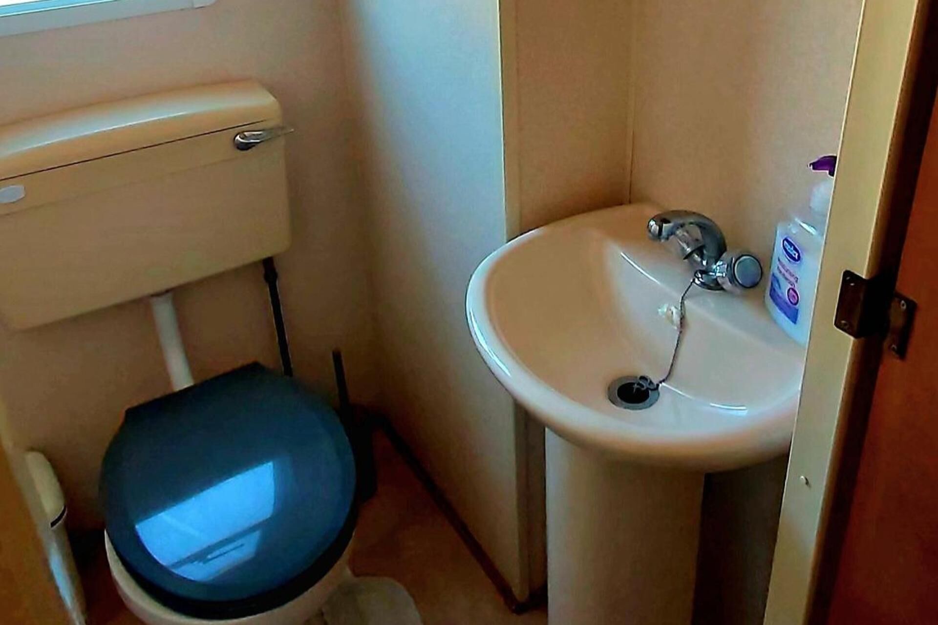 A small bathroom with a toilet and a sink.