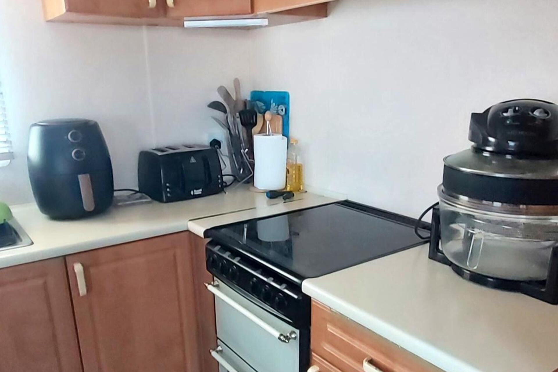 A kitchen with a stove, toaster, and coffee maker.
