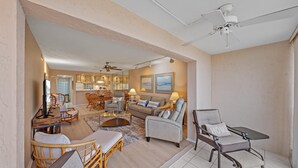A spacious living area with a dining set, a sofa, and a chair. - Mins to Beach, Tennis, Heated Pool, Bayside (Siesta Key)