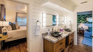 A bathroom with a double sink, wooden vanity, and a large mirror. - Waterfront Oasis with Boat Lift & Hot Tub in Bokeelia (Bokeelia)
