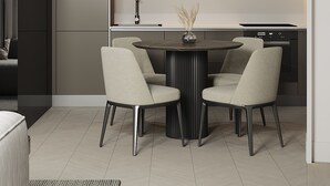 Een moderne keuken met een eethoek, met een ronde tafel en vier stoelen, een inbouwoven en een minimalistisch ontwerp.