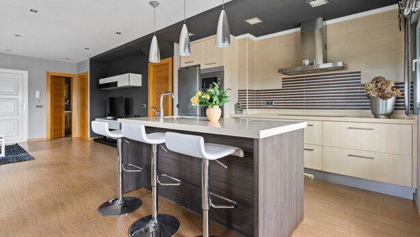 A modern kitchen with a central island, bar stools, pendant lighting, and a stainless steel range hood. - Vacation Home 'Santa Divina Relax Para 10 Personas' with Balcony and Wi-Fi (Asturias)
