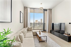 TV, offices - Modern 1BR in JVC with Pool Gym and Parking (Dubai)