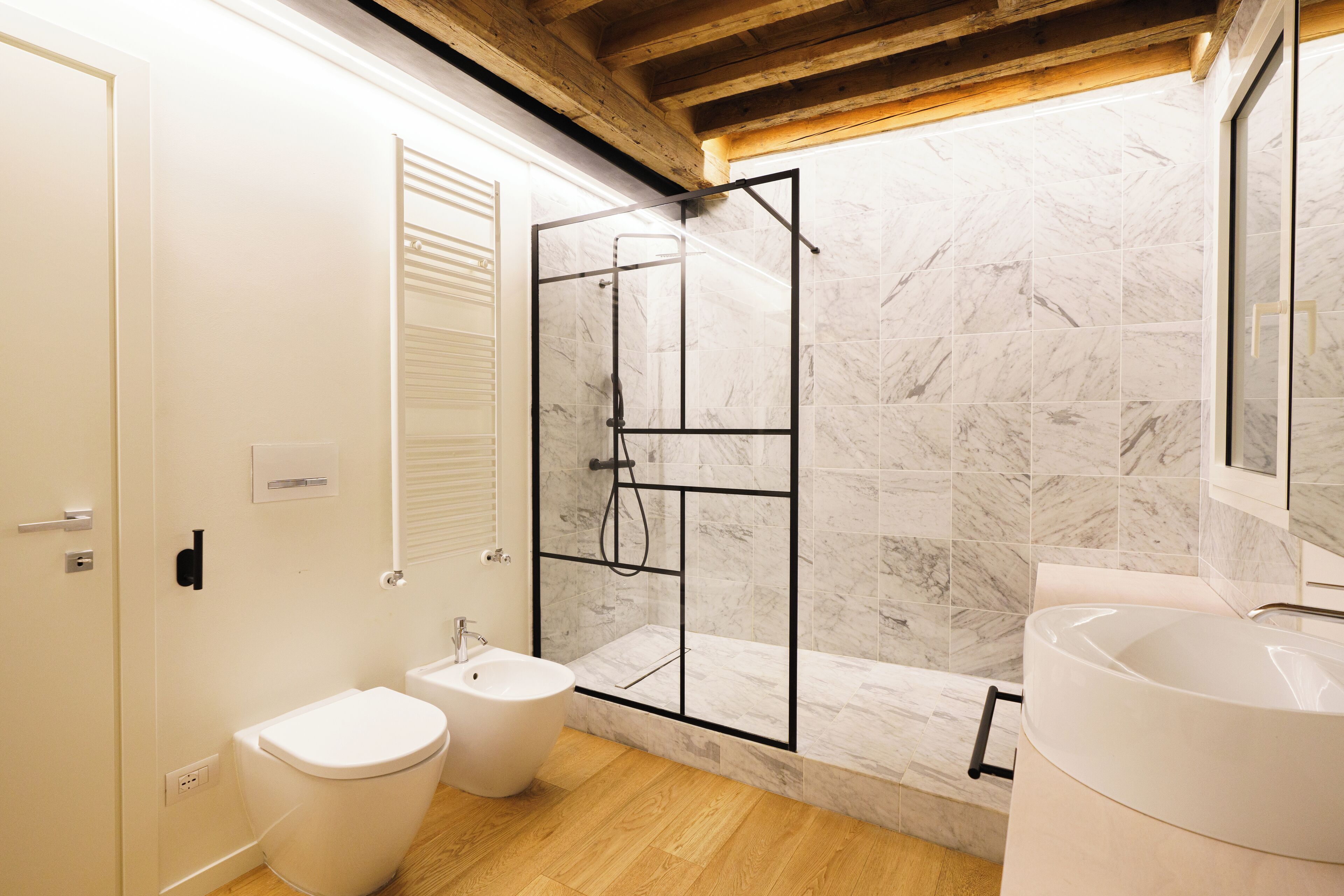 Une salle de bain moderne équipée d’une douche, de toilettes, d’un bidet et d’une baignoire.