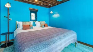 A bedroom with a large bed, a round side table, a floor lamp, and a window with a view. - Beijing Shixi Inn near Forbidding City (Beijing)
