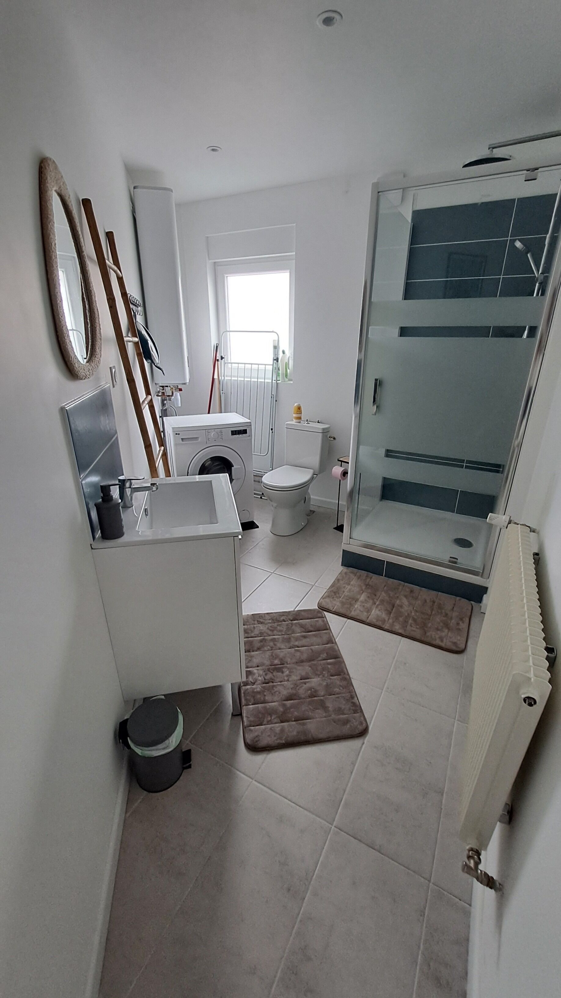 A modern bathroom with a toilet, sink, and shower.