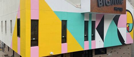 A colorful building with a sign for 'Big Little Hotel'.