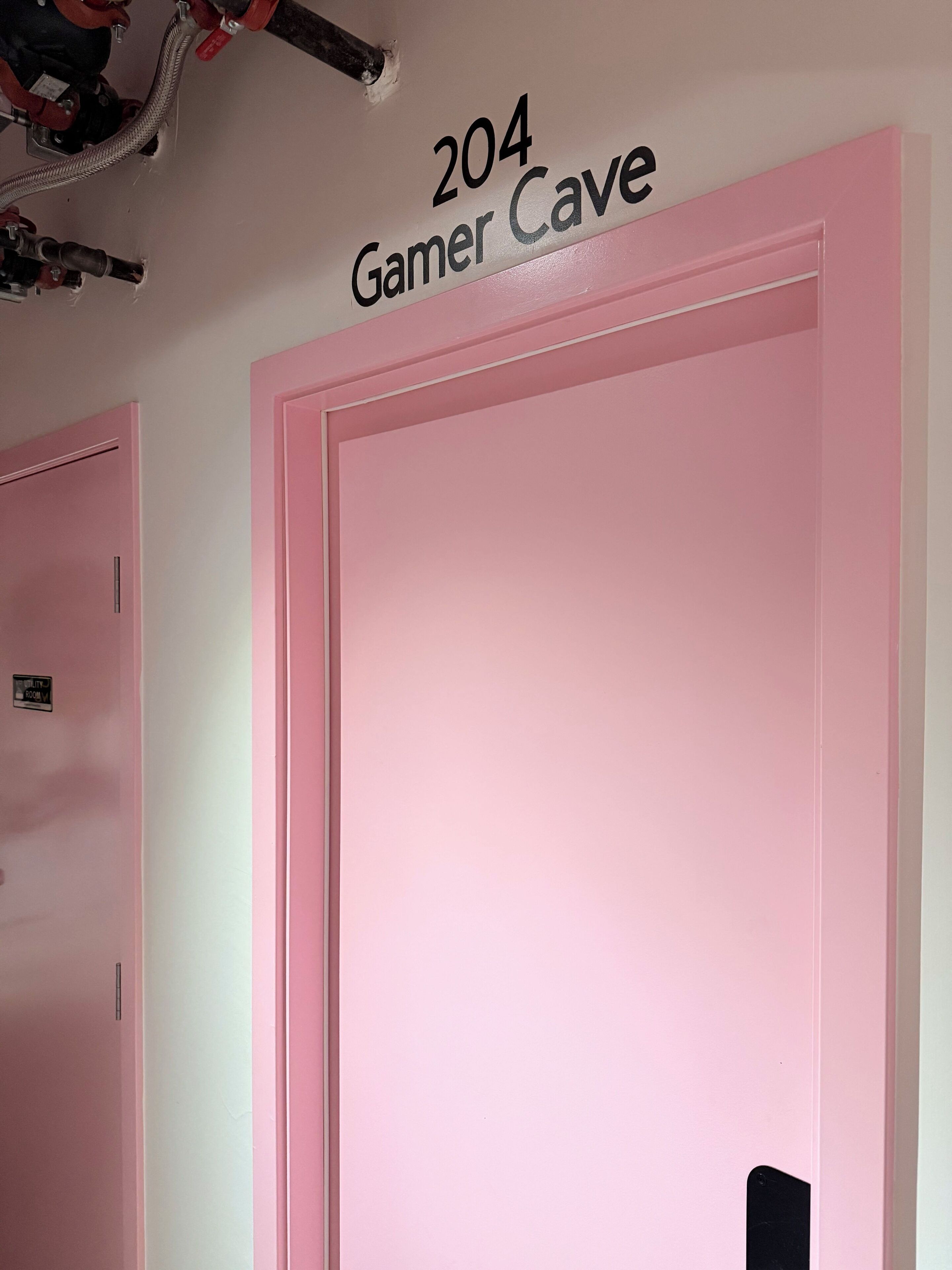 A room with a pink door labeled "204 Gamer Cave."