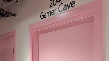 A room with a pink door labeled "204 Gamer Cave."