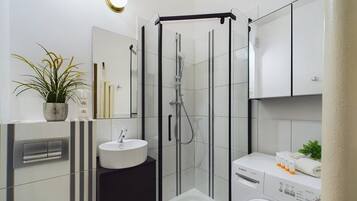Shower, hair dryer, towels, shampoo