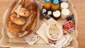 A breakfast tray with croissants, tea, milk, juice, and cheese. - Romantic Suite "Love Room" with Jacuzzi (Sainte-Eusoye)