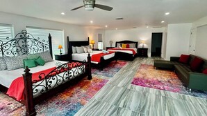 A hotel room with two beds, a ceiling fan, and a colorful rug. - Orange Bay Retreat - Amazing View (Fort Myers Beach)