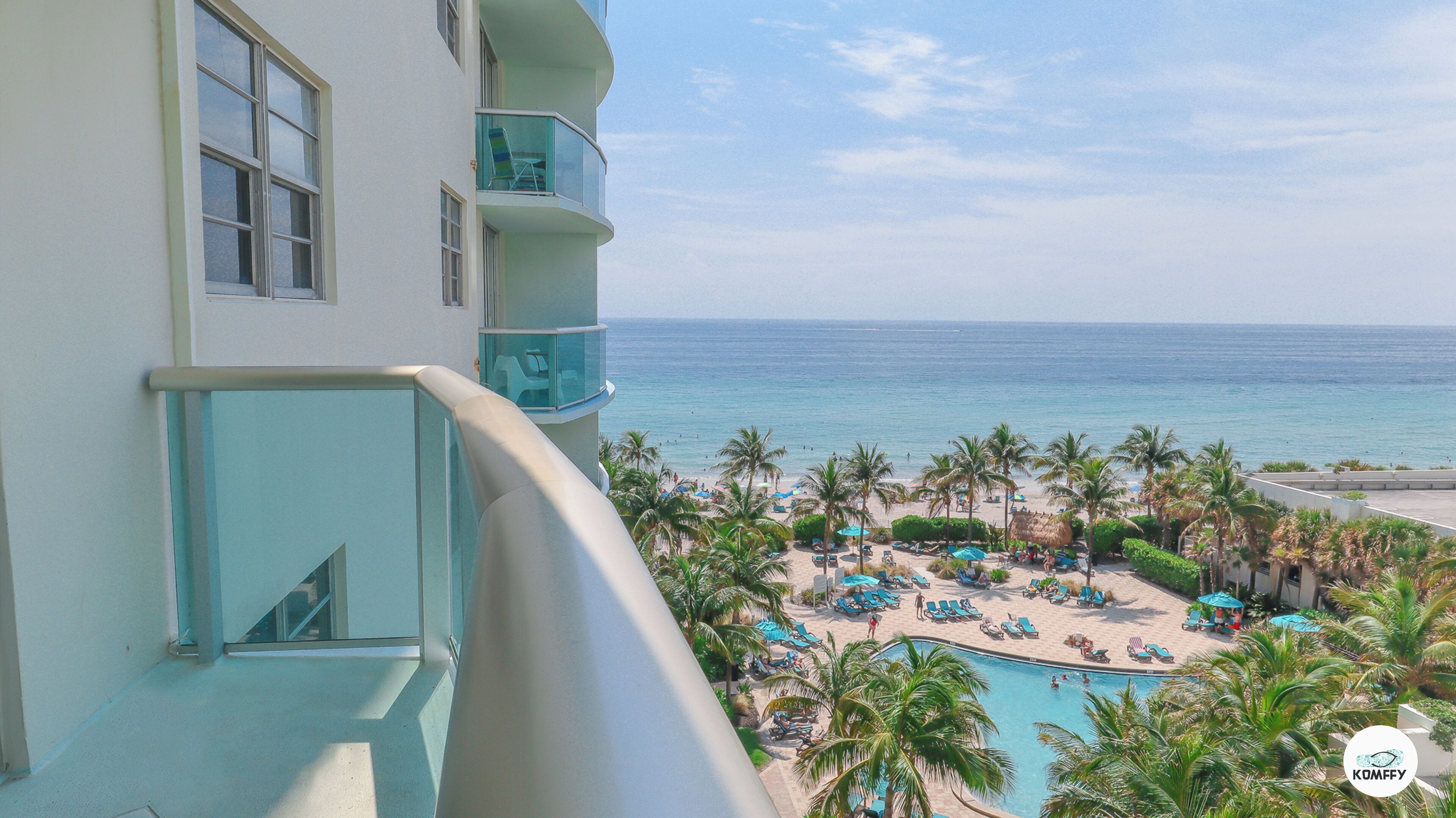 A resort with a pool, beach, and ocean view.
