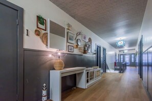 A modern kitchen with a central island, wooden flooring, and a staircase leading to another level. - Broadway 7 - Clean Private Studio (Redondo Beach)