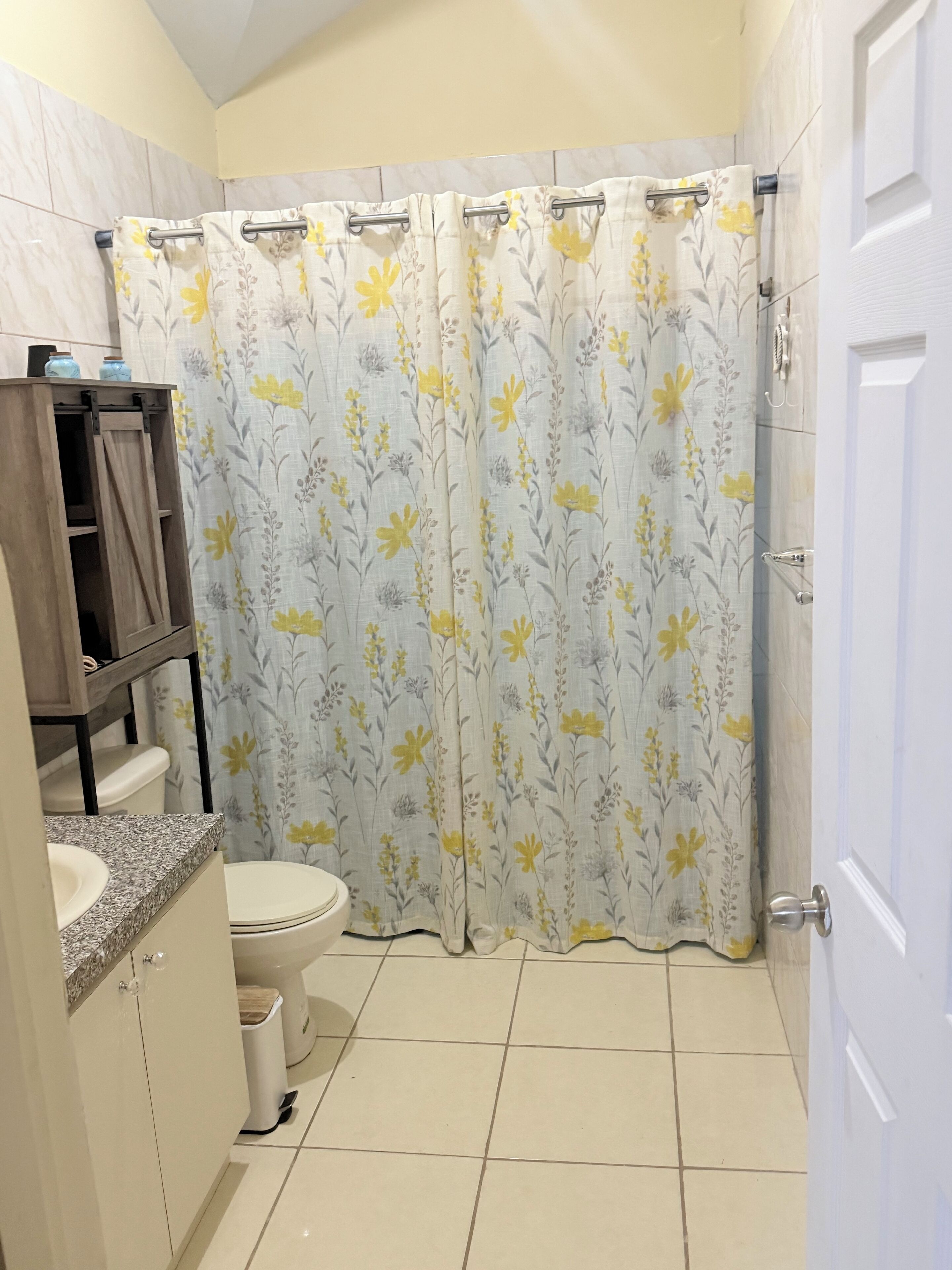 Ein Badezimmer mit Toilette, Waschbecken und Duschvorhang.