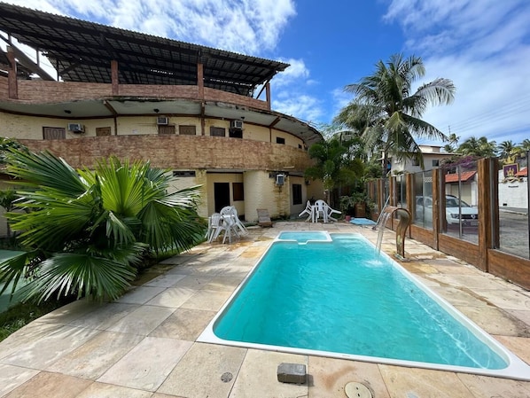 Outdoor pool, open 10:00 AM to 10:00 PM, pool umbrellas