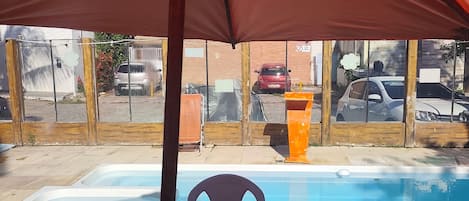 Outdoor pool, open 10:00 AM to 10:00 PM, pool umbrellas