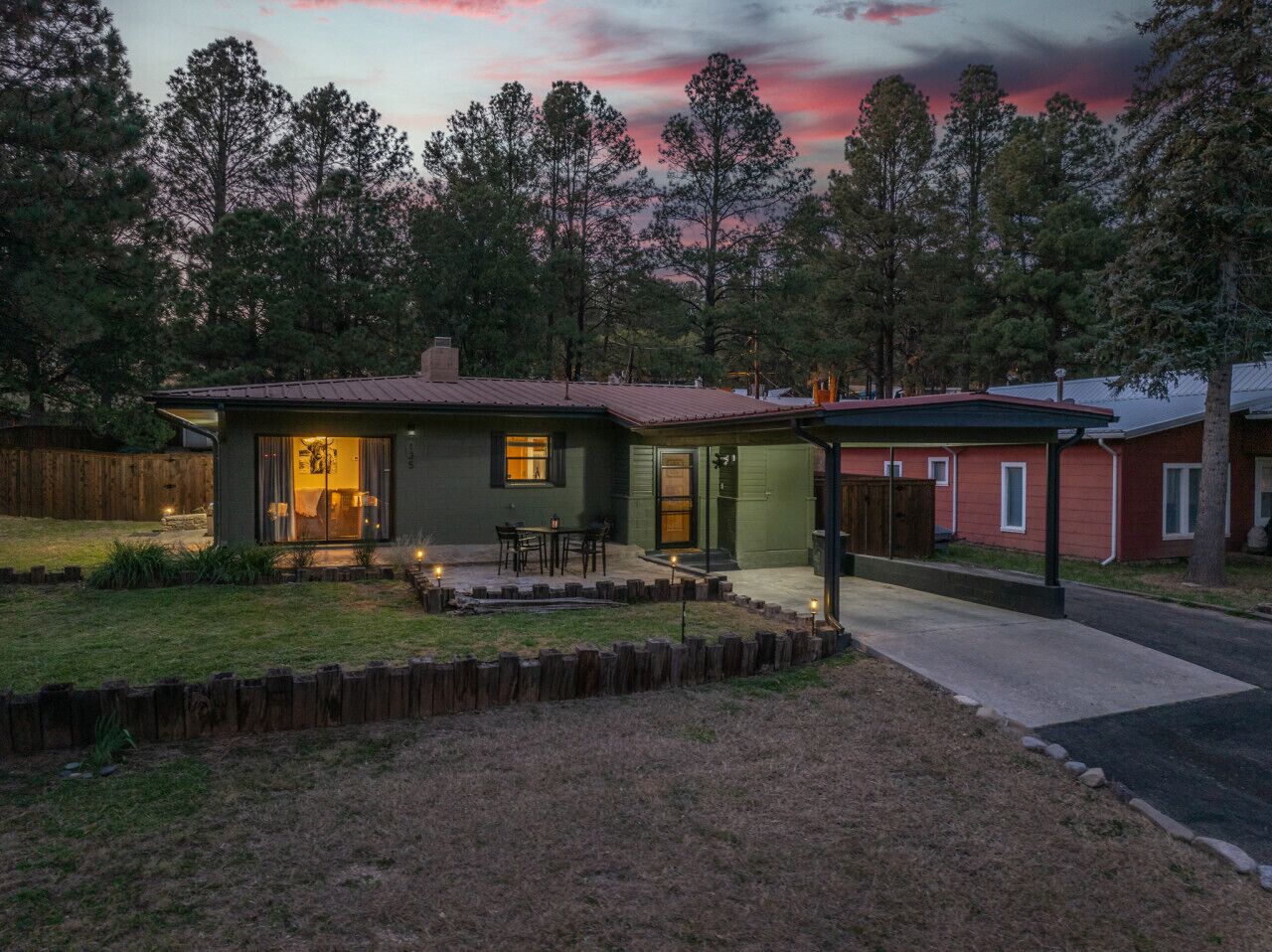 A single-story house with a covered patio and a fenced yard.