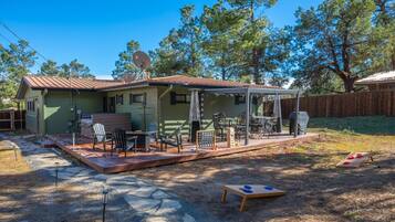 A house with a patio area, outdoor furniture, and a satellite dish.