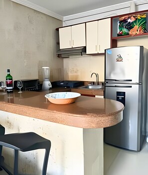 Fridge, coffee/tea maker, cookware/dishes/utensils