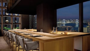 A modern conference room with a long table, chairs, and a view of a cityscape at dusk. - JW Marriott Hotel Tokyo (Tokyo)