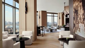 A spacious lobby with high ceilings, large windows offering a city view, and modern furniture. - JW Marriott Hotel Tokyo (Tokyo)