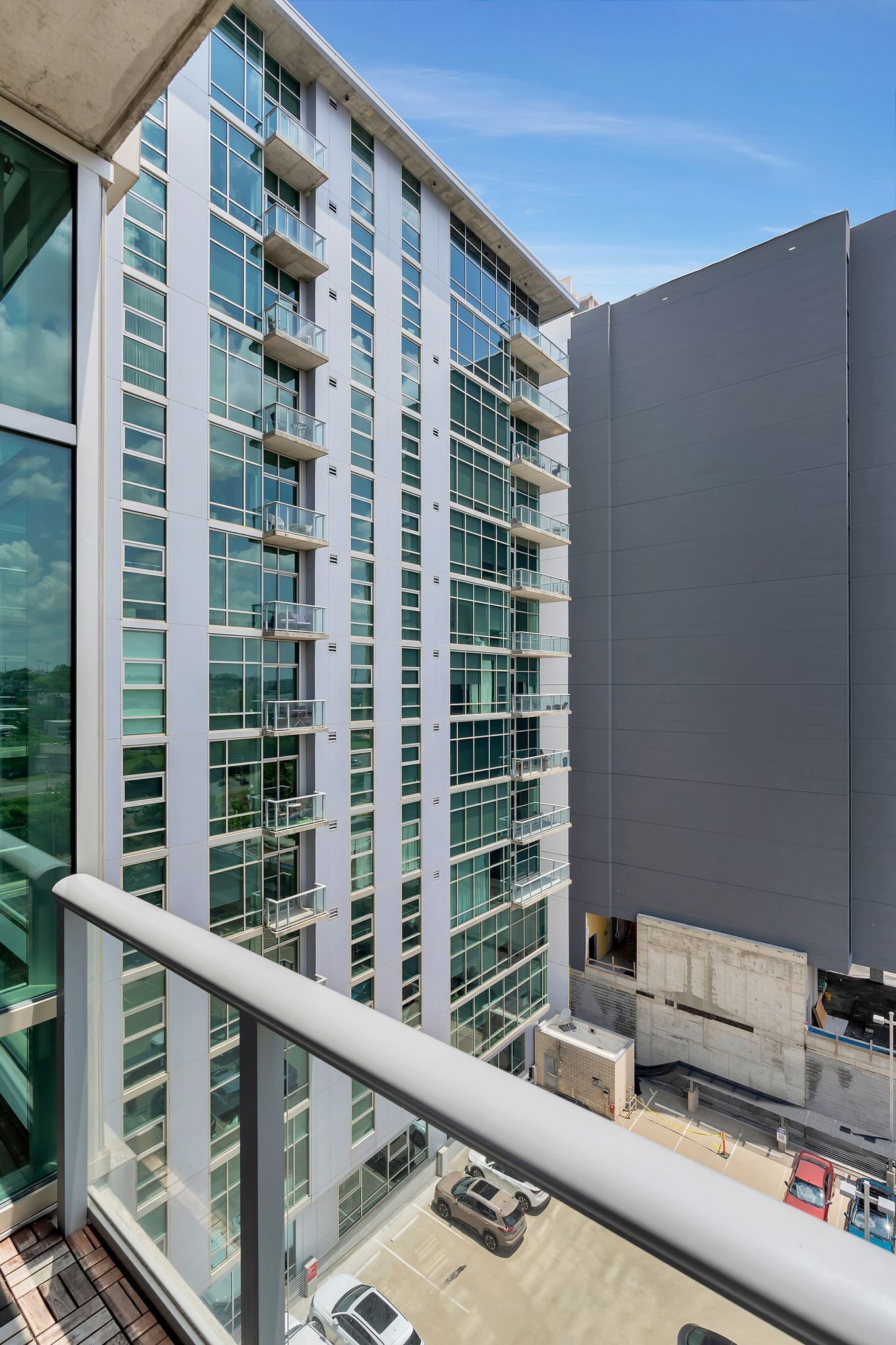 A modern building with multiple balconies and large windows.