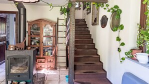 A staircase leading to a landing with a wooden cabinet and a stove. - Del Respiro by Interhome (Asti)
