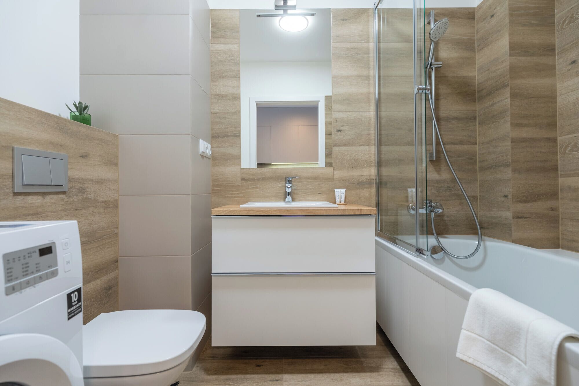 A modern bathroom with a toilet, sink, and shower.