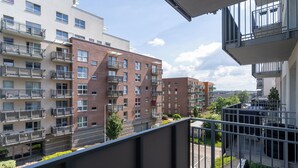 A multi-story residential building with balconies, a parking area, and a clear sky. - Business Deluxe Studio 19 (Katowice)
