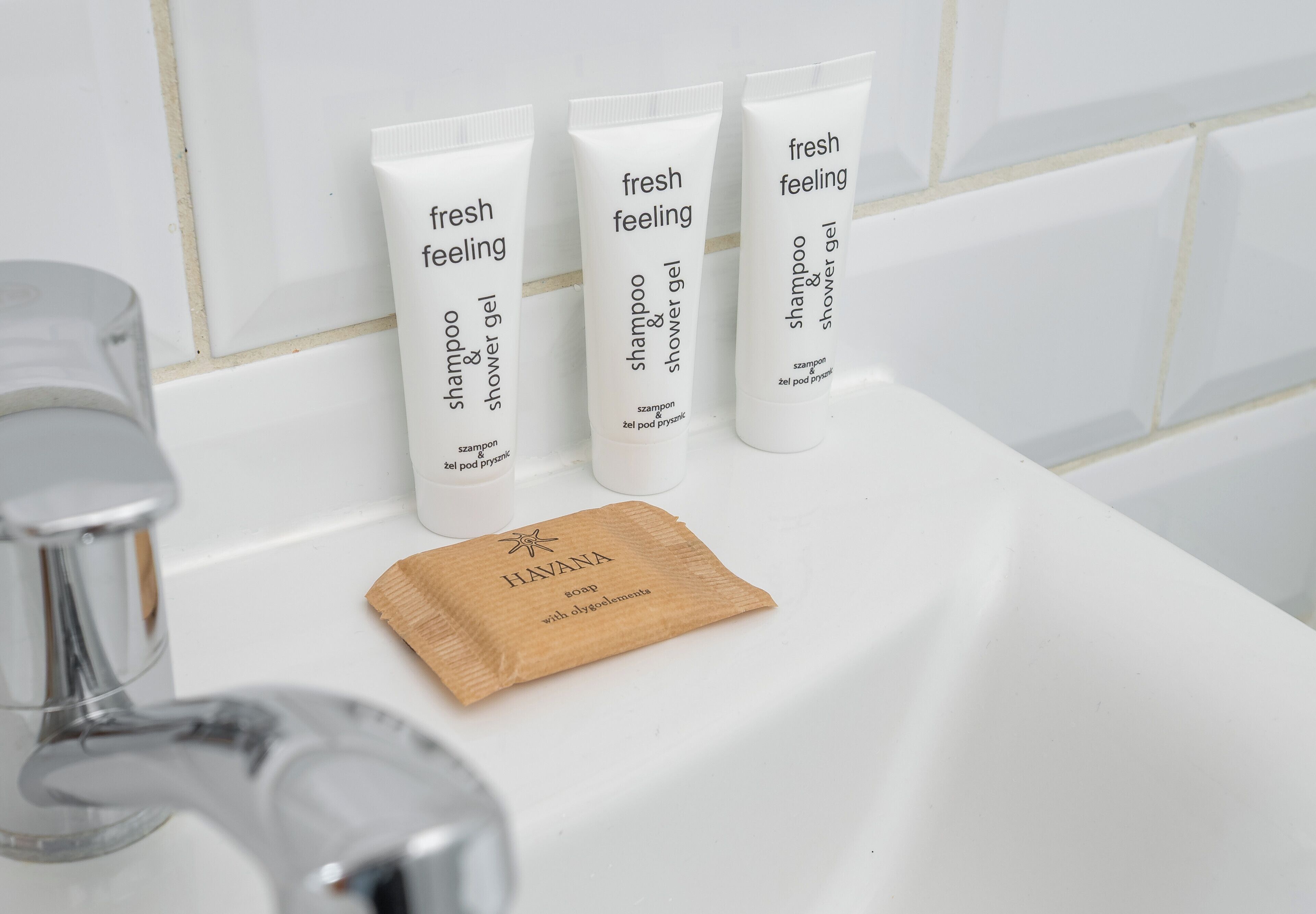 Three toiletries on a bathroom sink.