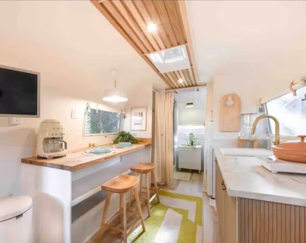 Fridge, microwave, coffee/tea maker, cookware/dishes/utensils