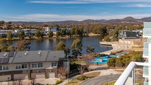 A residential area with a lake, modern houses, and a swimming pool. - The Greenway Edit Canberra, ACT (Greenway)