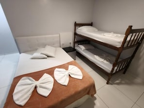 A room with a single bed, a wooden bunk bed, and a small bedside table. - Hotel Vitória - Guaíra PR (Guaíra)
