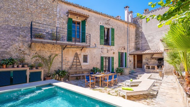 A stone building with a swimming pool, outdoor seating, and potted plants. - CASA MALLORQUINA CON ENCANTO - Rustic village house with private pool and free WiFi (Mancor de la Vall)