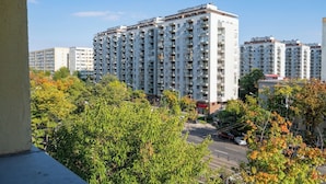 A high-rise residential building with multiple balconies and a central courtyard. - Golden Glow Hideaway (Bucharest)
