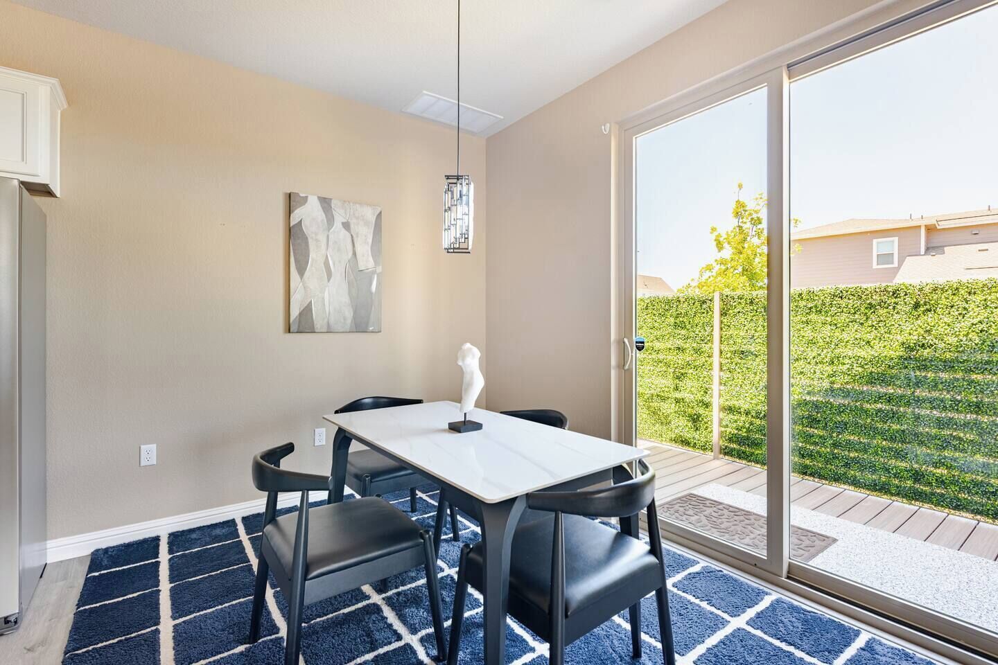 A dining area with a table, chairs, and a sculpture.