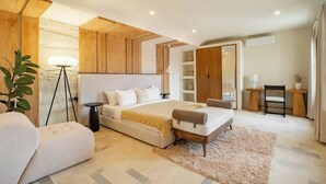 A modern bedroom with a large bed, bedside tables, a desk, and a chair. - 3BR Luxe Pool Villa Anaya (Canggu)