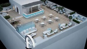 A modern outdoor seating area with tables and chairs, a pool, and a building labeled 'MONEE.' - Gulou Lanting Hotel  (Beijing)