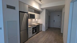 A modern kitchen with stainless steel appliances, a microwave, and a sink.